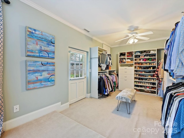 walk in closet featuring light colored carpet and ceiling fan