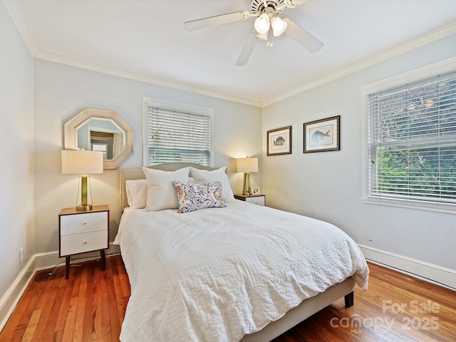 bedroom featuring dark wood-type flooring, ornamental molding, and ceiling fan