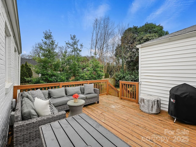 wooden deck featuring area for grilling and an outdoor hangout area