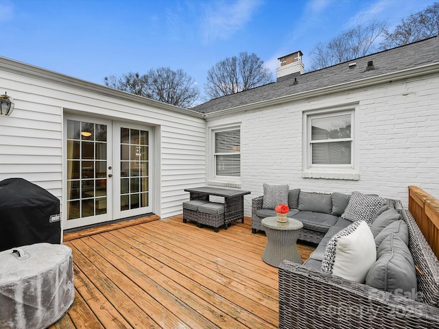 wooden deck featuring french doors, area for grilling, and an outdoor hangout area