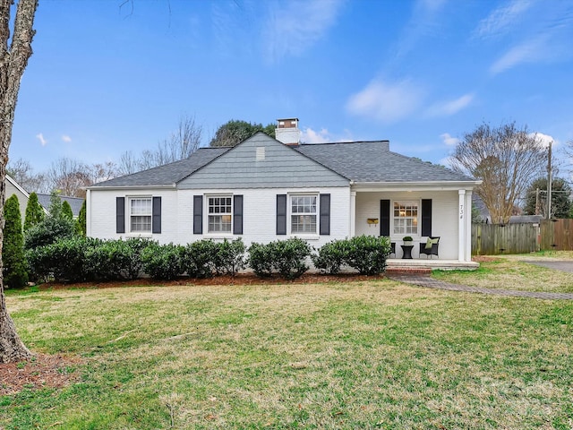 ranch-style home featuring a porch and a front lawn