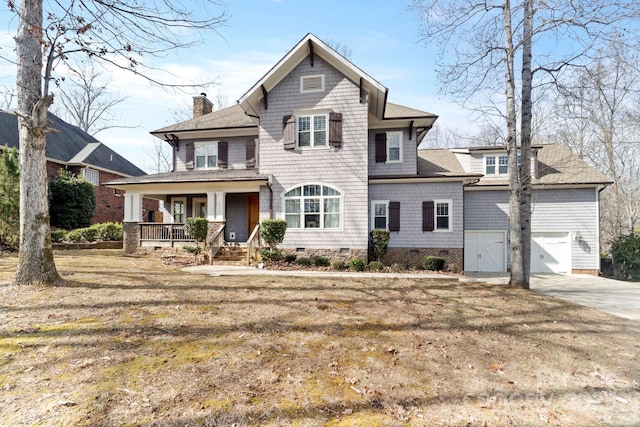 view of front property featuring a porch, a front lawn, and a garage