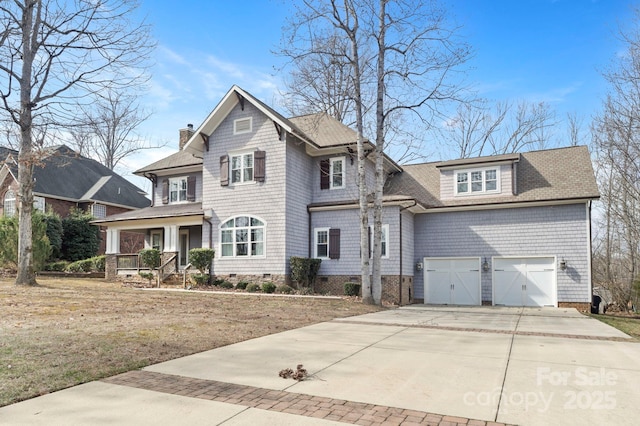 view of front facade featuring a porch, a front yard, and a garage