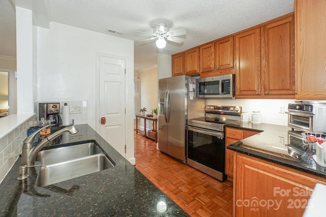 405 NW Dr, Davidson, NC 28036 - kitchen with sink, tasteful backsplash, dark stone counters, stainless steel appliances, and light parquet floors