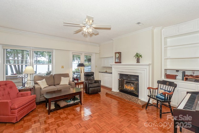 405 NW Dr, Davidson, NC 28036 - living room with a tiled fireplace, crown molding, light parquet flooring, and a textured ceiling