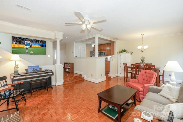 405 NW Dr, Davidson, NC 28036 - living room featuring light parquet floors, crown molding, ceiling fan with notable chandelier, and decorative columns