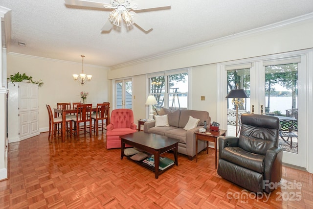405 NW Dr, Davidson, NC 28036 - living room with ceiling fan with notable chandelier, ornamental molding, light parquet flooring, and a textured ceiling