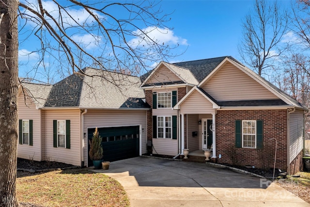 traditional-style home featuring an attached garage, roof with shingles, concrete driveway, and brick siding