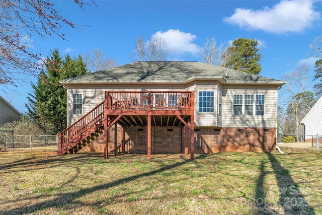 rear view of house with a wooden deck, fence, stairway, and a yard