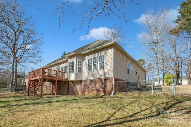 rear view of property with a yard, stairway, a gate, fence, and a wooden deck