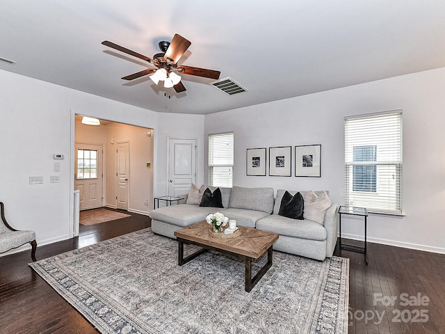 living room with ceiling fan and dark hardwood / wood-style flooring