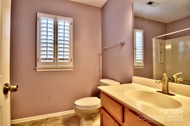 bathroom with baseboards, visible vents, toilet, walk in shower, and vanity