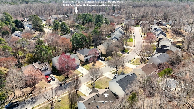 aerial view featuring a residential view and a wooded view