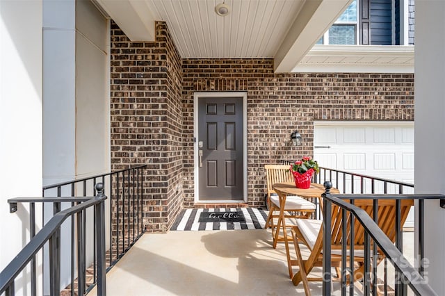 view of exterior entry with brick siding