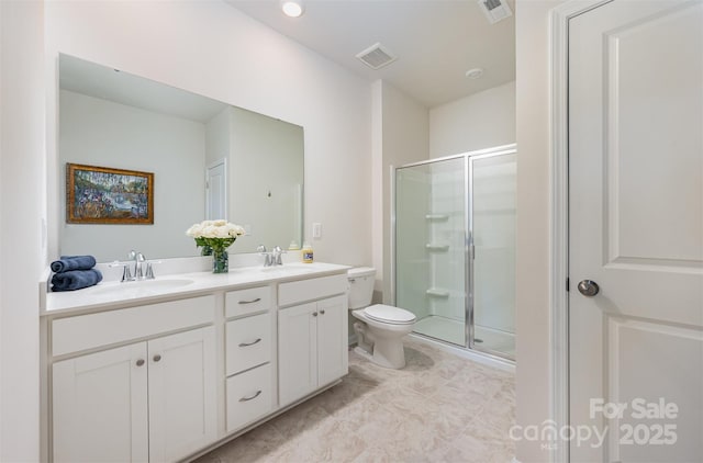 bathroom with toilet, visible vents, and a sink