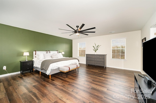 bedroom with visible vents, dark wood-type flooring, a ceiling fan, and baseboards