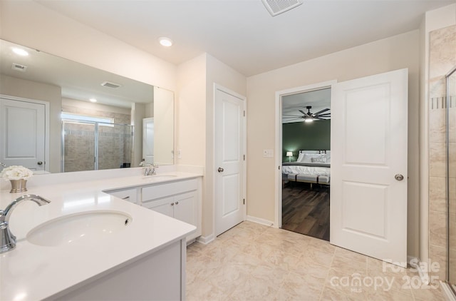 ensuite bathroom with a sink, a shower stall, visible vents, and connected bathroom