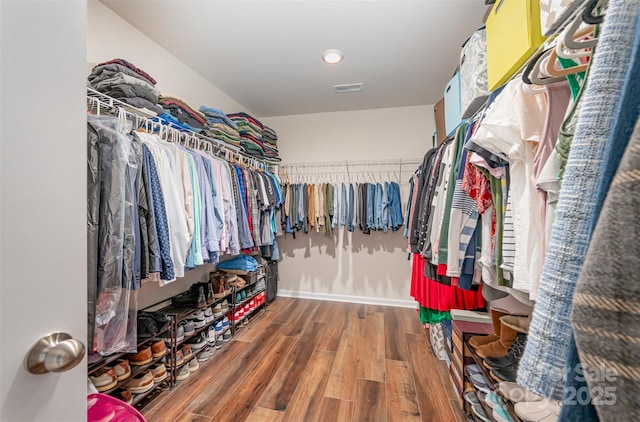 walk in closet featuring wood finished floors and visible vents