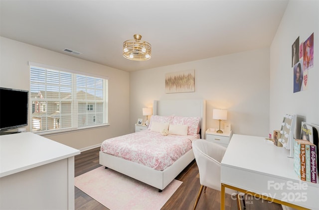 bedroom featuring dark wood-style flooring and visible vents