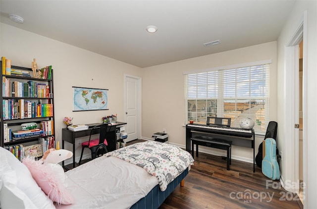 bedroom with dark wood-type flooring, visible vents, and baseboards