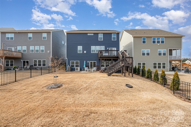 back of property featuring a fenced backyard, a deck, and stairs