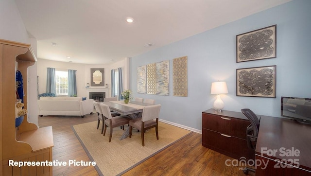 dining space with hardwood / wood-style flooring