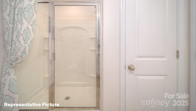 bathroom with a shower with shower door