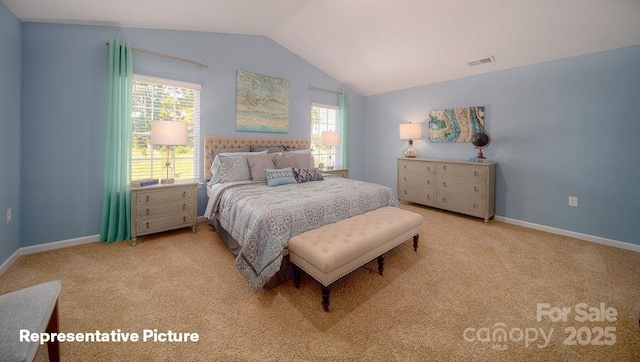 bedroom with lofted ceiling and light colored carpet