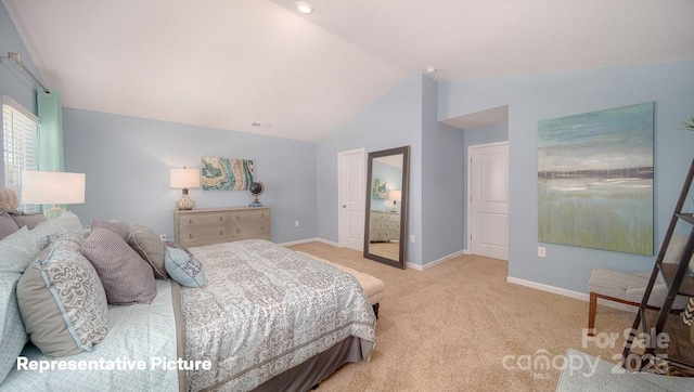 bedroom with lofted ceiling and light carpet