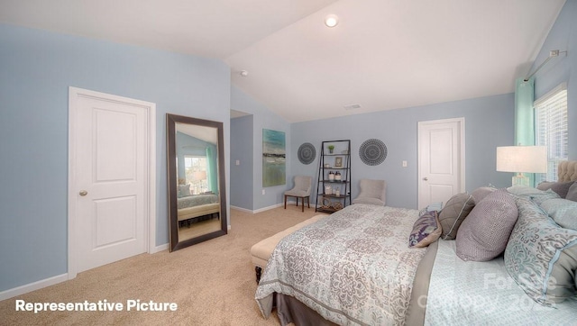 carpeted bedroom with lofted ceiling