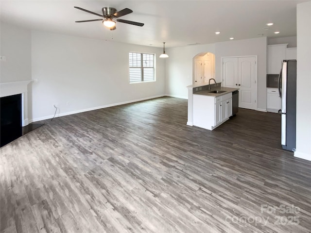 kitchen with ceiling fan, stainless steel appliances, dark hardwood / wood-style flooring, and sink