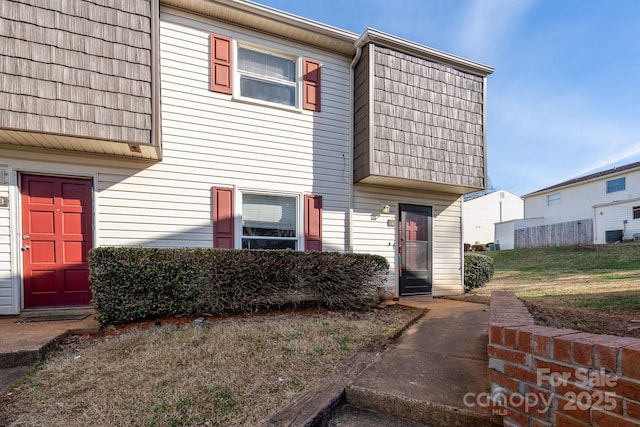 townhome / multi-family property with mansard roof