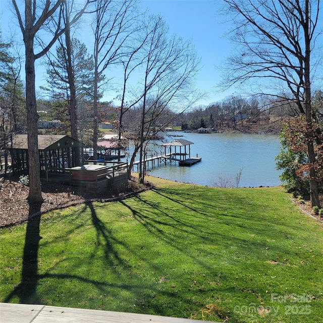 exterior space with a water view and a lawn