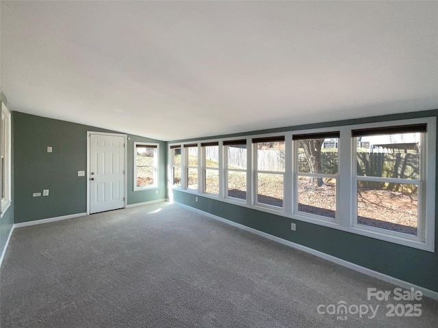 unfurnished sunroom featuring lofted ceiling