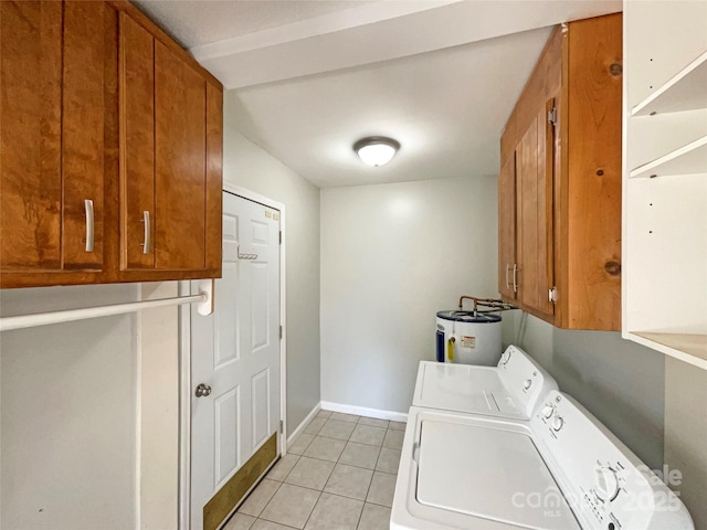 washroom featuring cabinets, independent washer and dryer, water heater, and light tile patterned floors