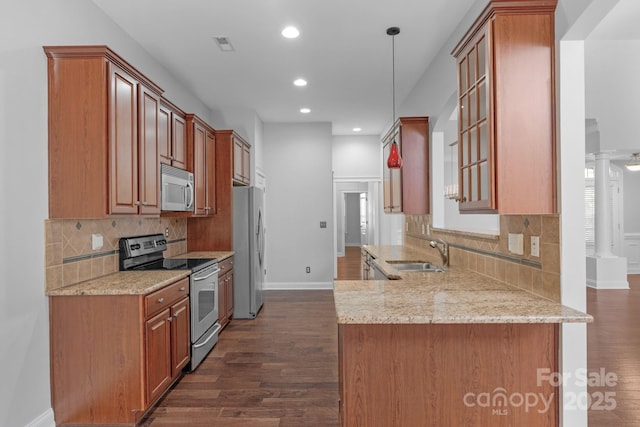 3009 Scottcrest Way, Waxhaw, NC 28173 - kitchen with stainless steel appliances, a sink, dark wood-type flooring, recessed lighting, and light stone countertops