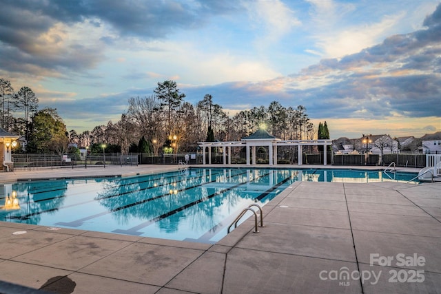 3009 Scottcrest Way, Waxhaw, NC 28173 - pool at dusk with fence, a community pool, and a patio