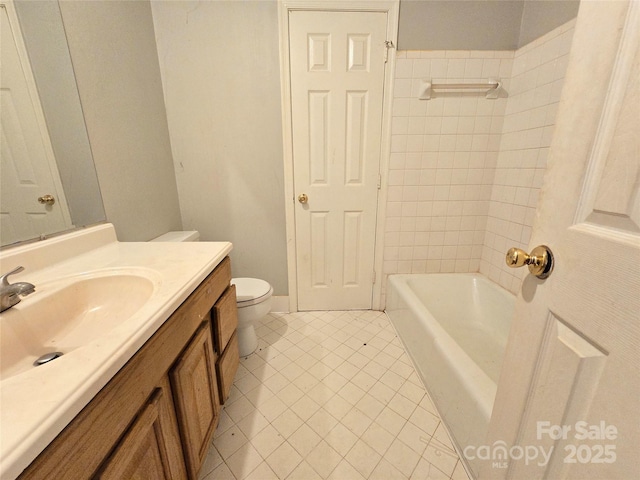 bathroom featuring vanity, toilet, and tile patterned flooring