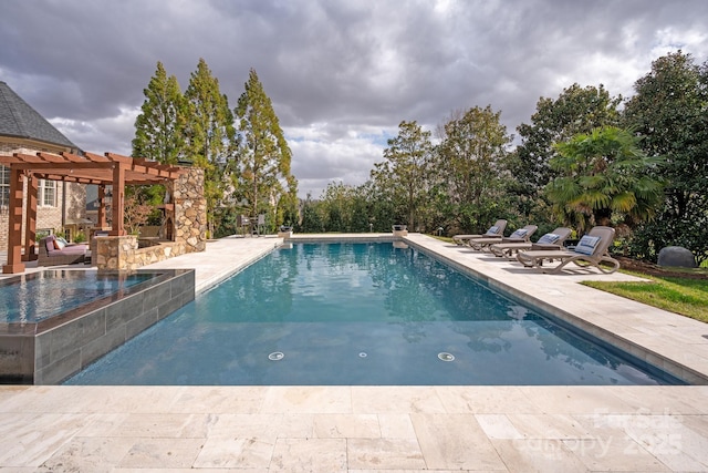 outdoor pool featuring a patio, an in ground hot tub, and a pergola