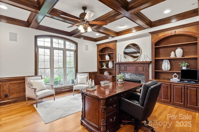 office featuring built in shelves, coffered ceiling, beam ceiling, and wainscoting