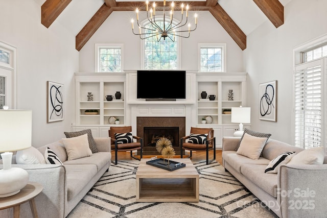 living room featuring a healthy amount of sunlight, a fireplace with flush hearth, high vaulted ceiling, and beamed ceiling