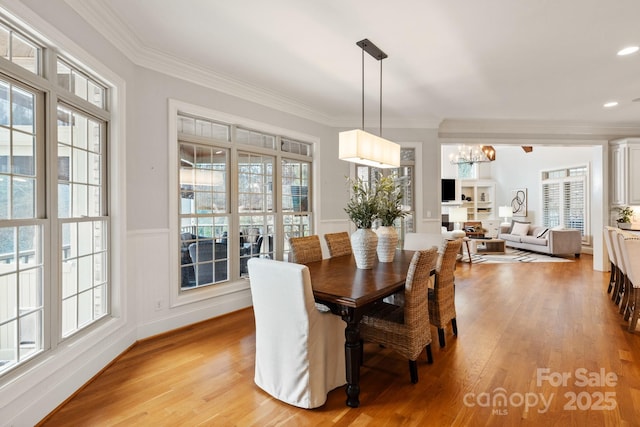 dining space with light wood-style floors, recessed lighting, and ornamental molding