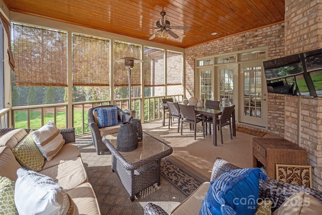 sunroom / solarium with wood ceiling and ceiling fan