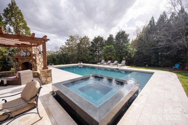 pool featuring a patio area, an outdoor stone fireplace, and an in ground hot tub