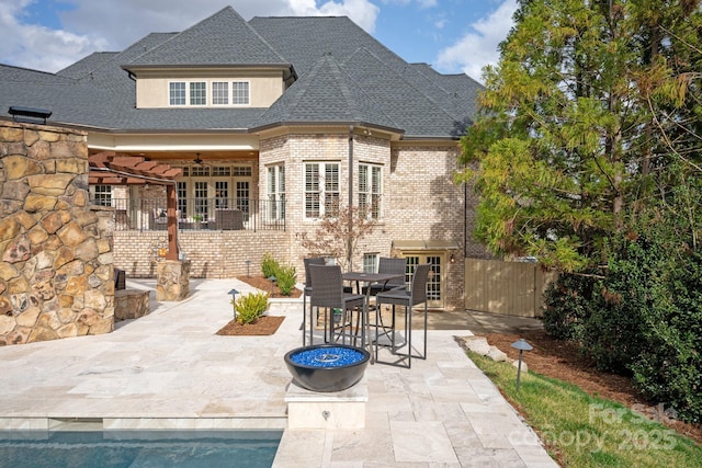 rear view of house featuring a patio area, fence, a ceiling fan, and brick siding