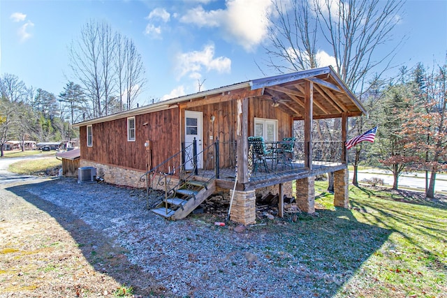 view of side of home with central AC unit