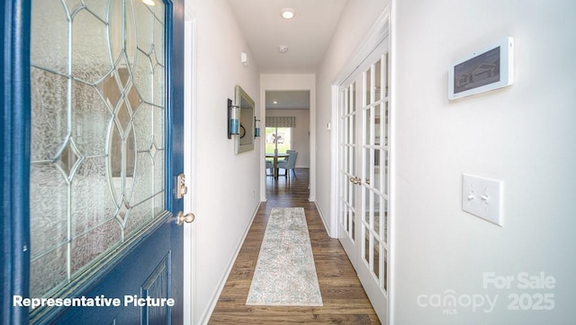 hallway featuring dark wood-type flooring and french doors