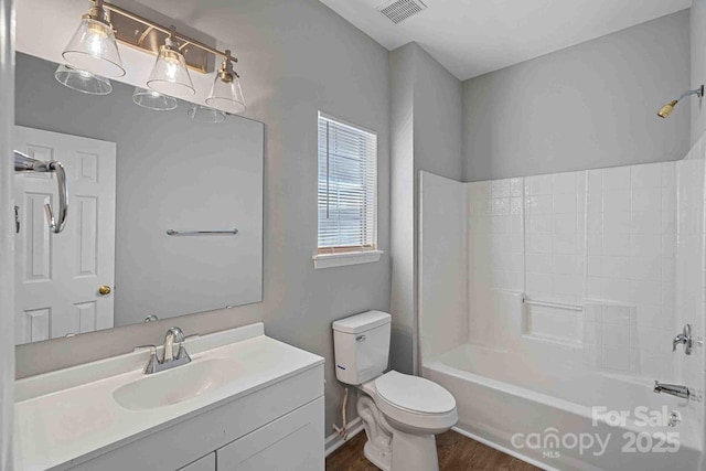 full bathroom with hardwood / wood-style flooring, vanity, toilet, and  shower combination