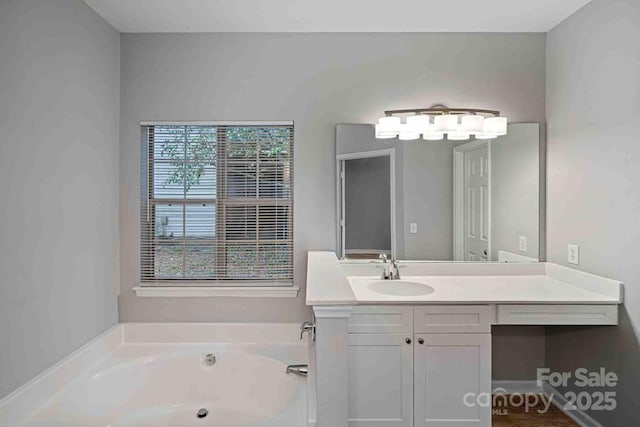 bathroom featuring vanity and a washtub