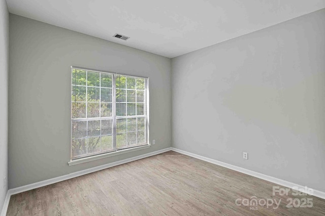 unfurnished room with light wood-type flooring